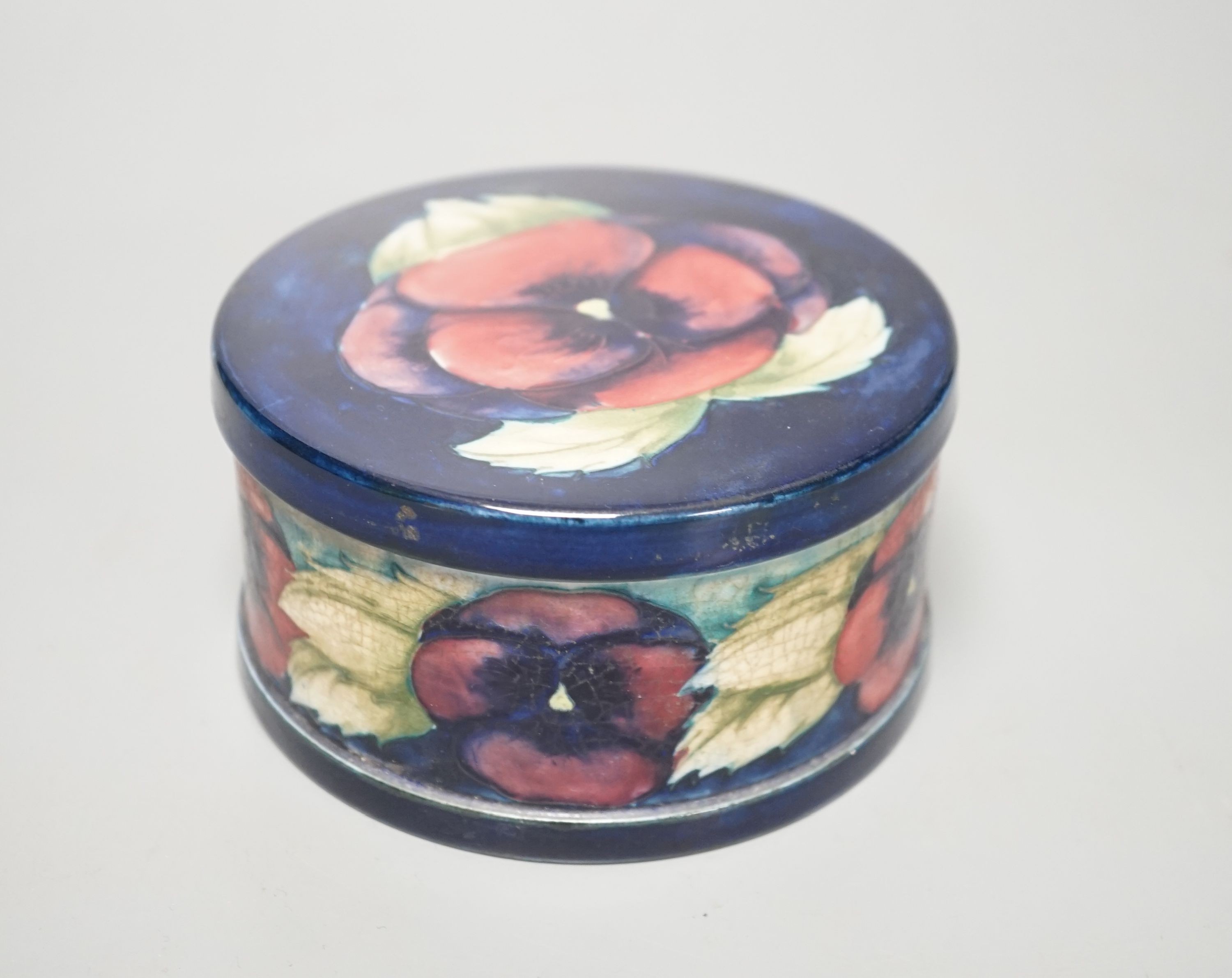 A Moorcroft pansy pattern circular box and cover, diameter 12cm